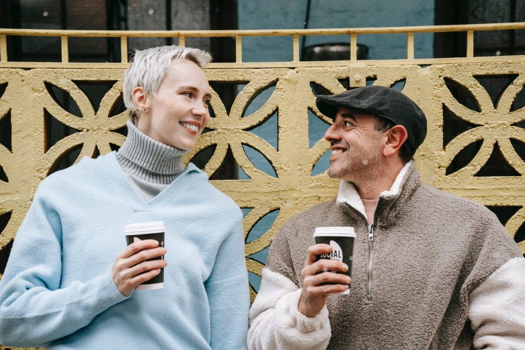 smiling couple with coffee in their hands